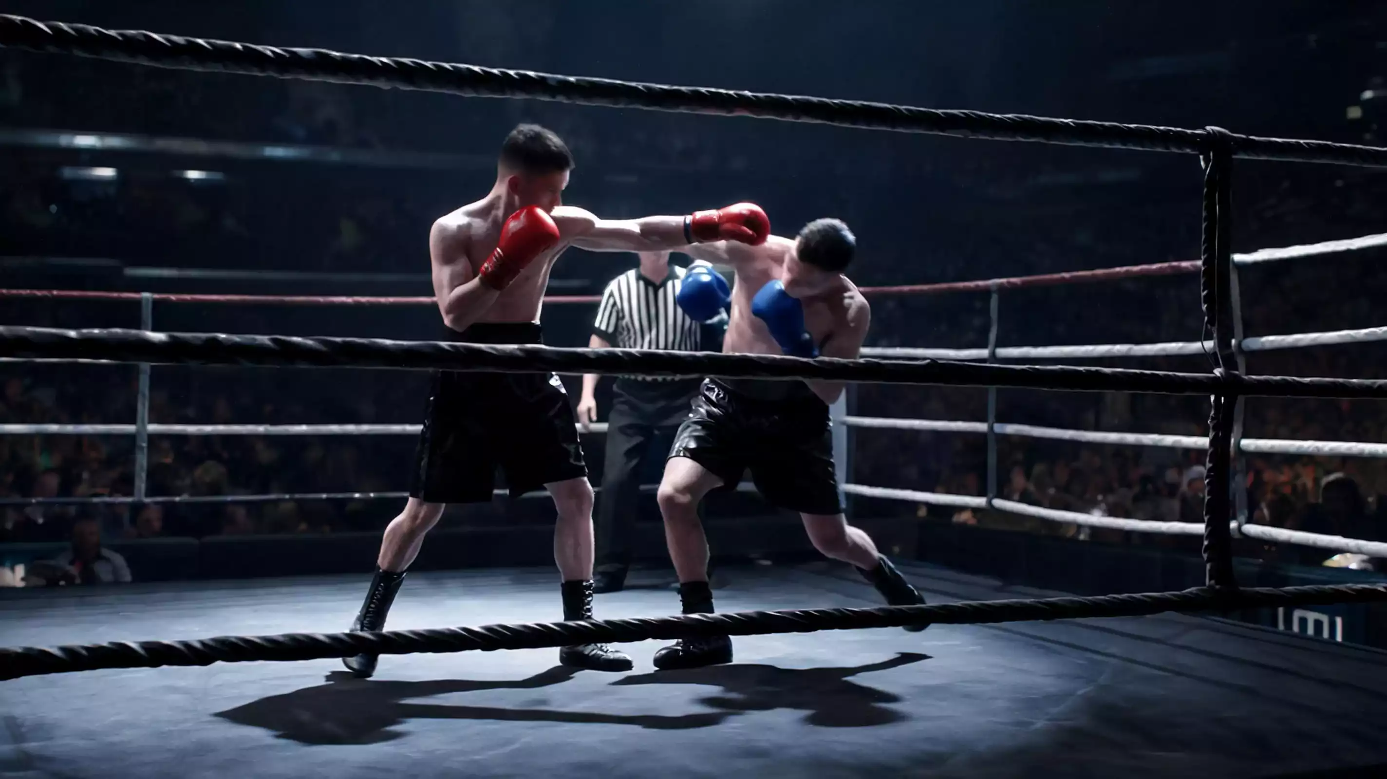 Two boxers exchanging punches mid-round in a professional boxing match under arena lights
